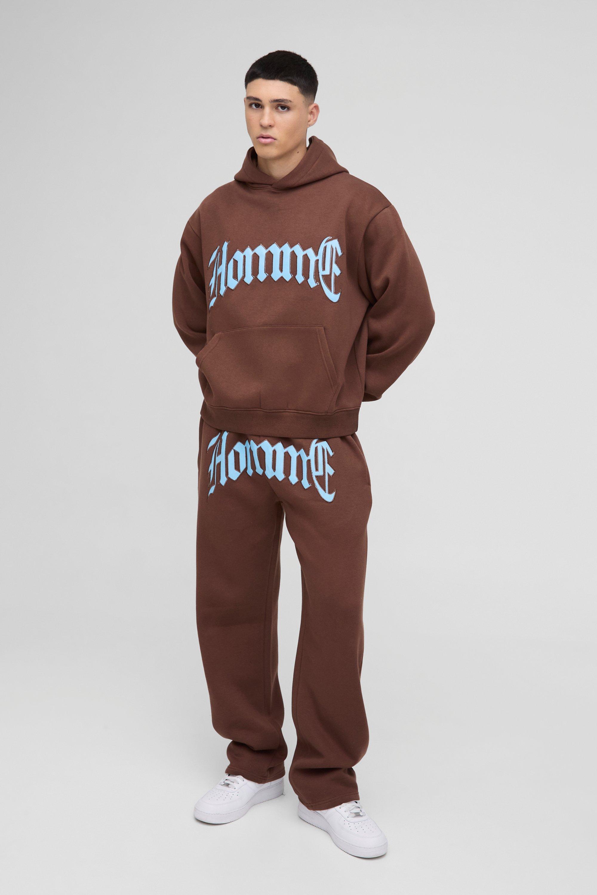 Tuta Sportiva Squadrata Oversize Homme In Pu Con Applique E Cappuccio, Brown