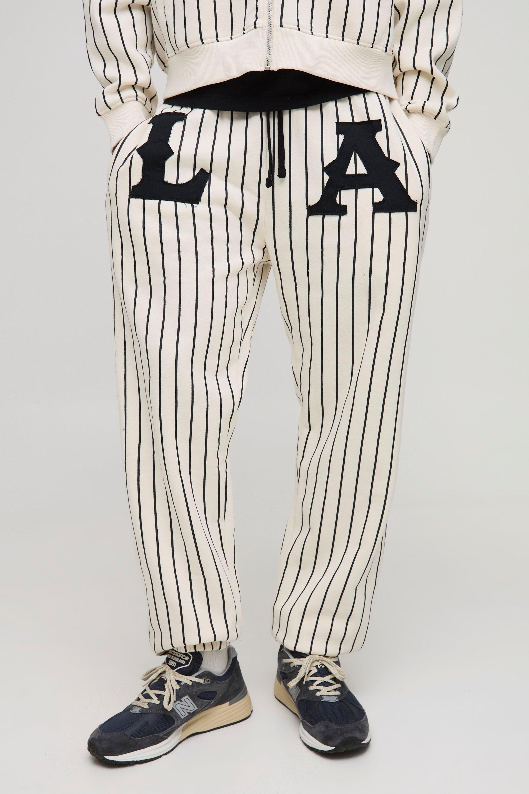 Image of Pantaloni tuta rilassati a righe verticali con applique LA, Cream
