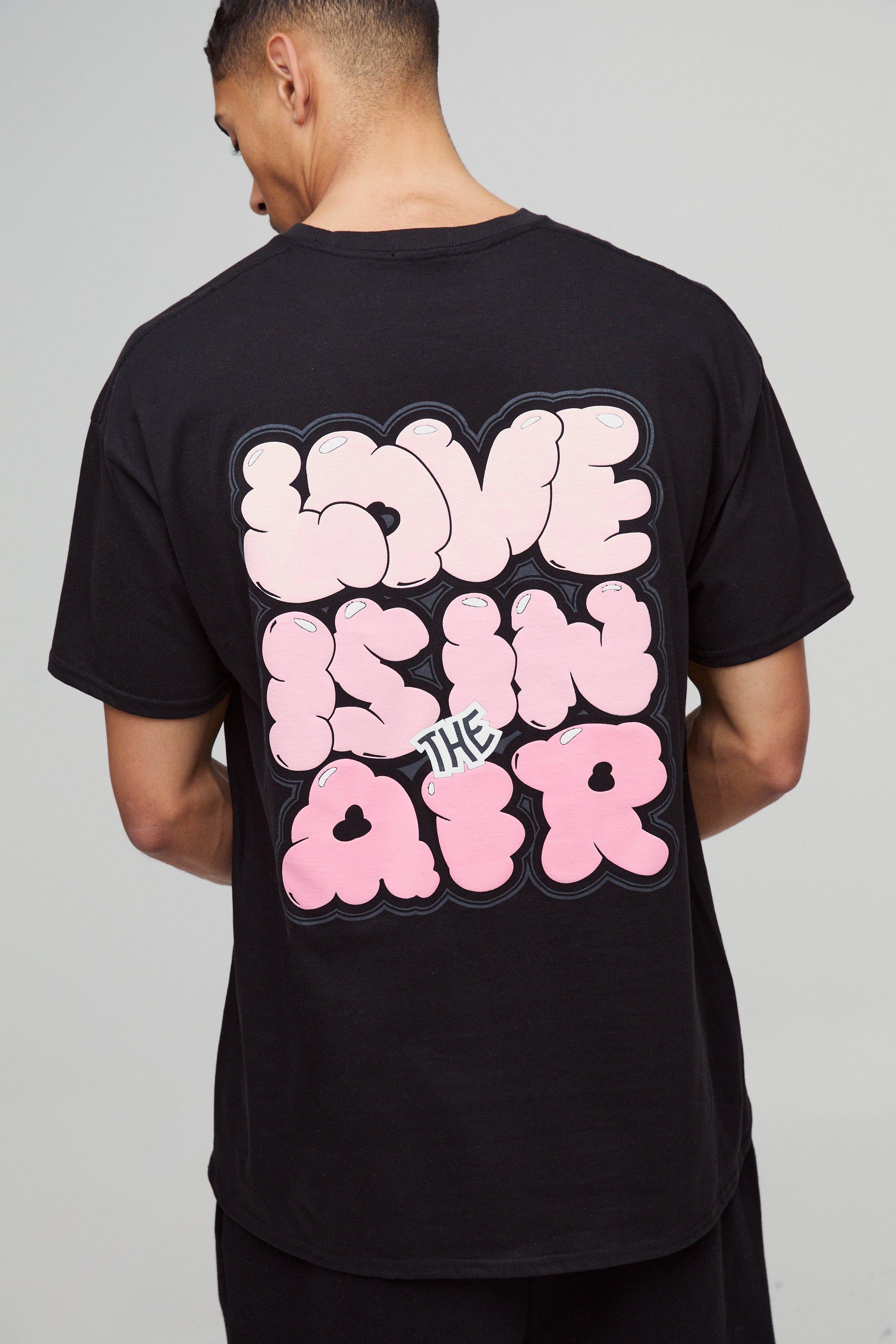 T-shirt oversize con stampa a caratteri arrotondati Love Is In The Air, Nero