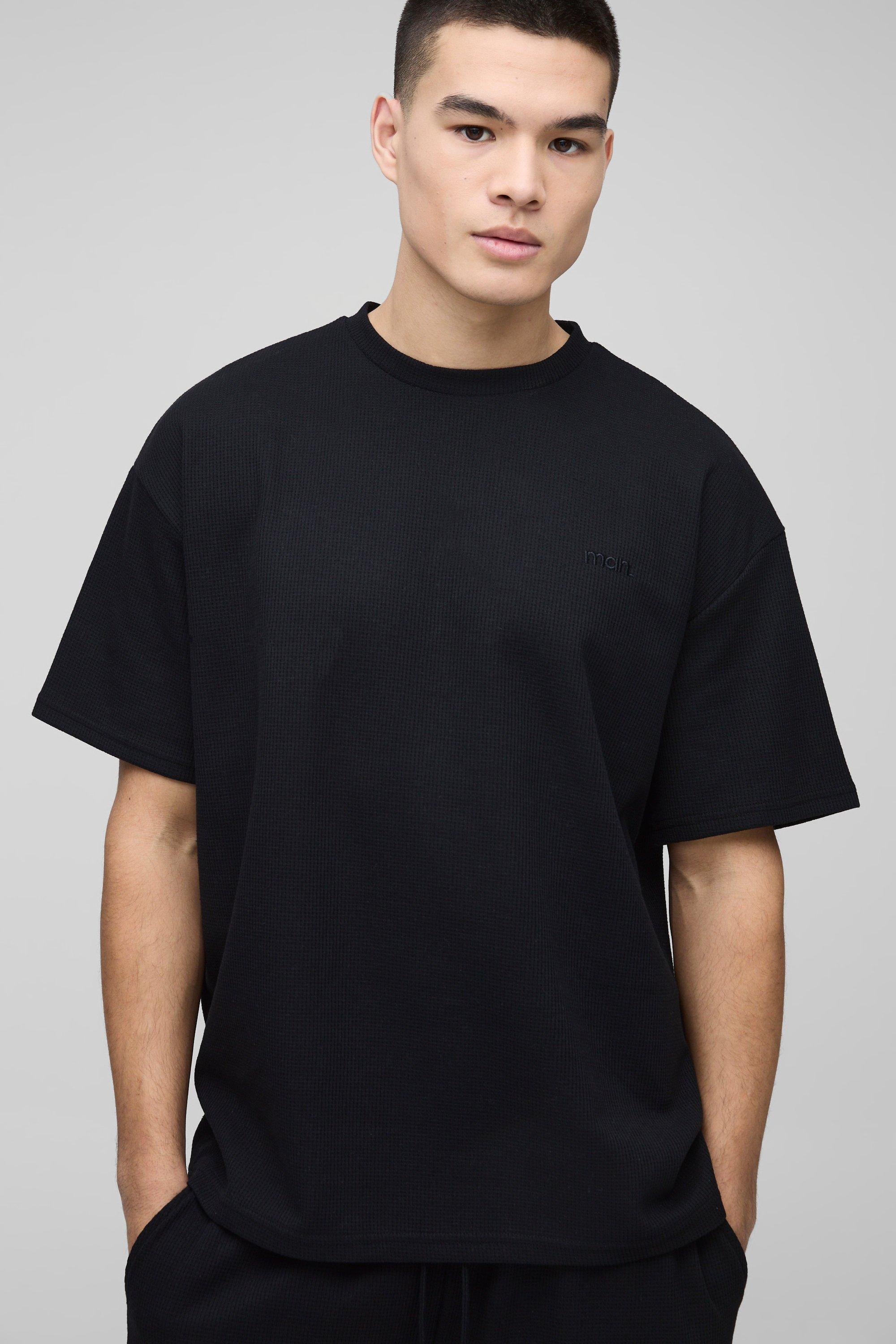 T-shirt oversize con ricamo Man e trama a nido d'ape, Nero