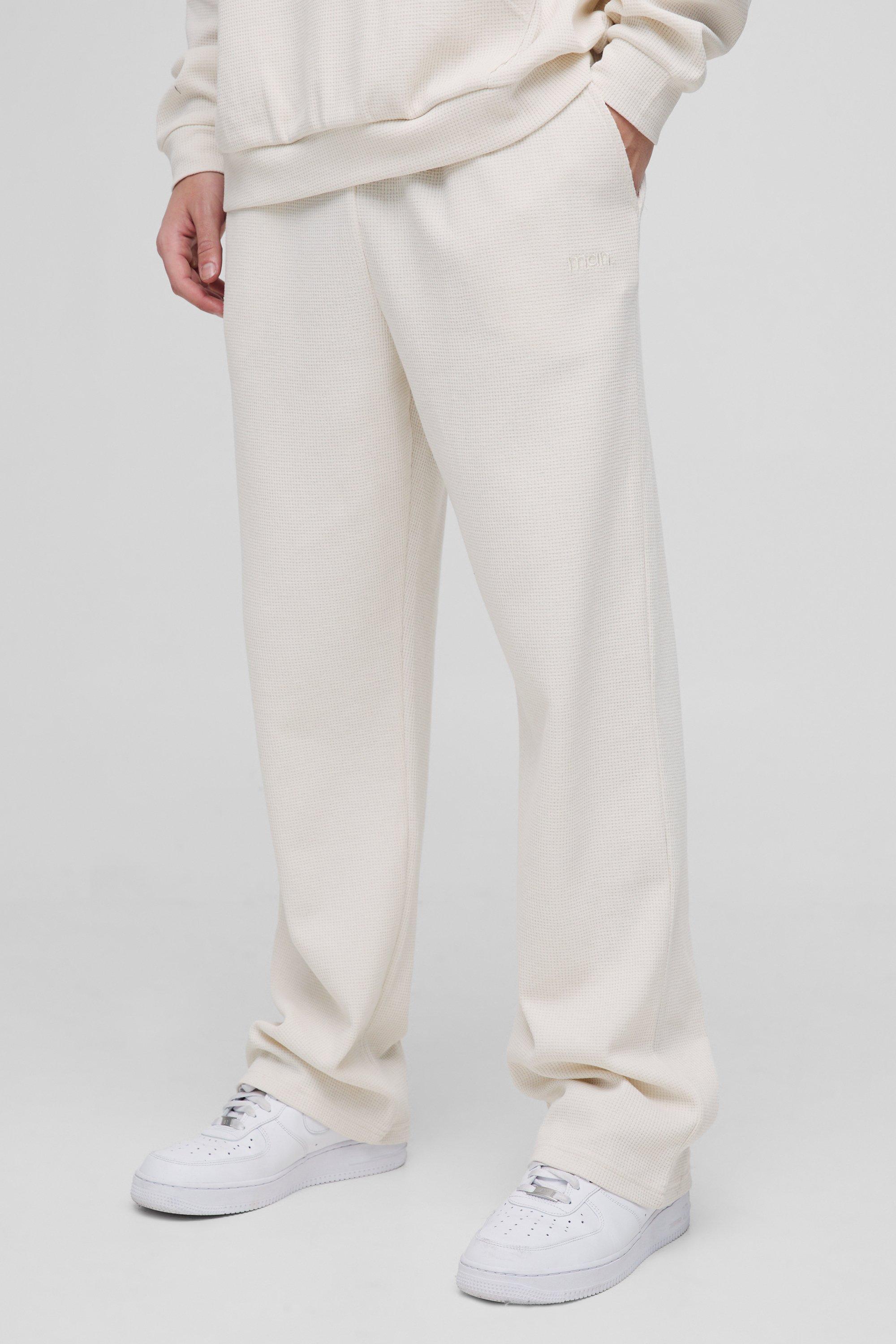 Pantaloni tuta dritti con ricamo Man e trama a nido d'ape, Cream