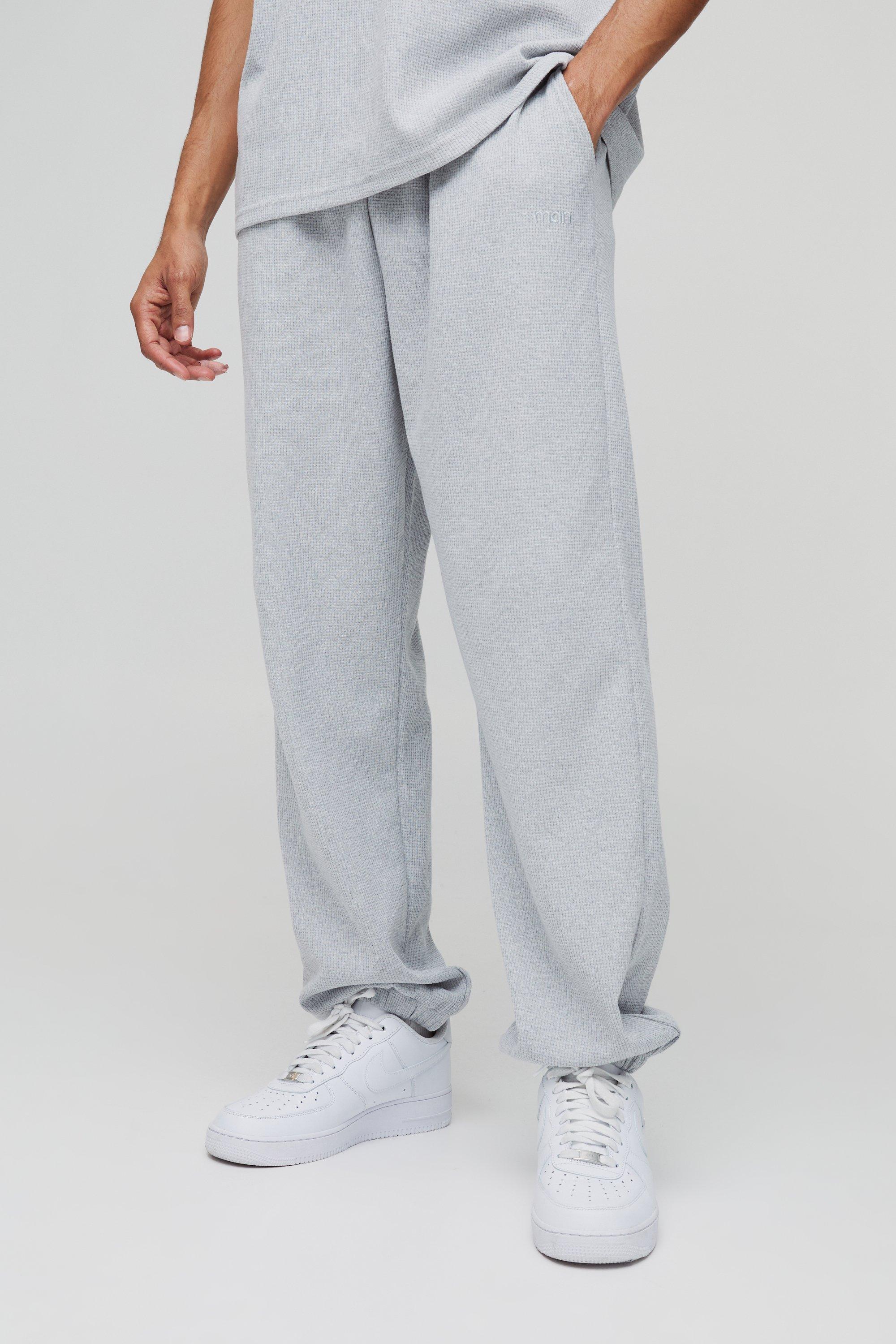 Pantaloni tuta oversize Man con ricami a nido d'ape e polsini alle caviglie, Grigio