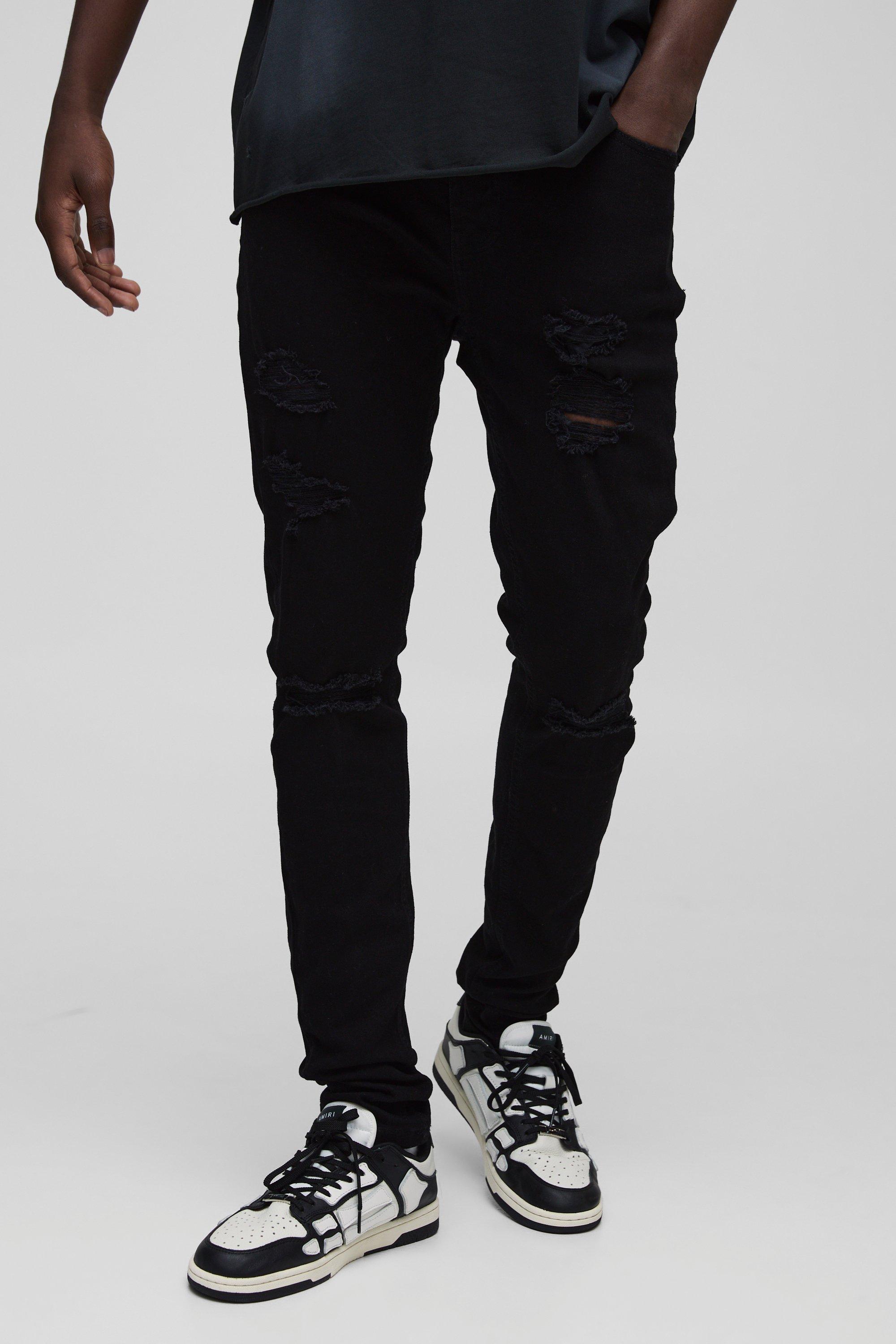 Image of Jeans Skinny Fit strappati con pieghe sul fondo e smagliature, Nero