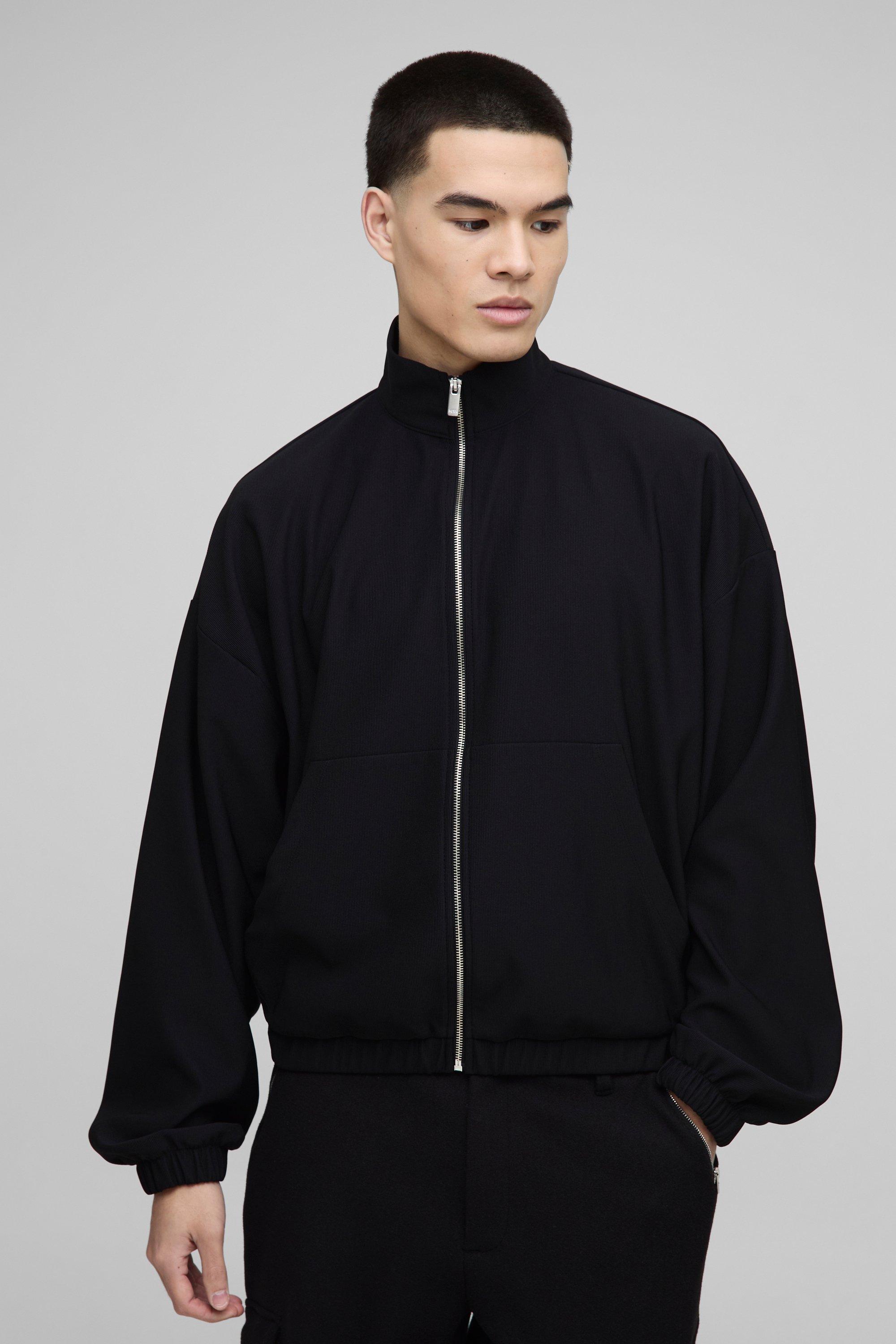 Image of Top da corsa squadrato oversize con maniche a palloncino, zip e collo a imbuto, Nero