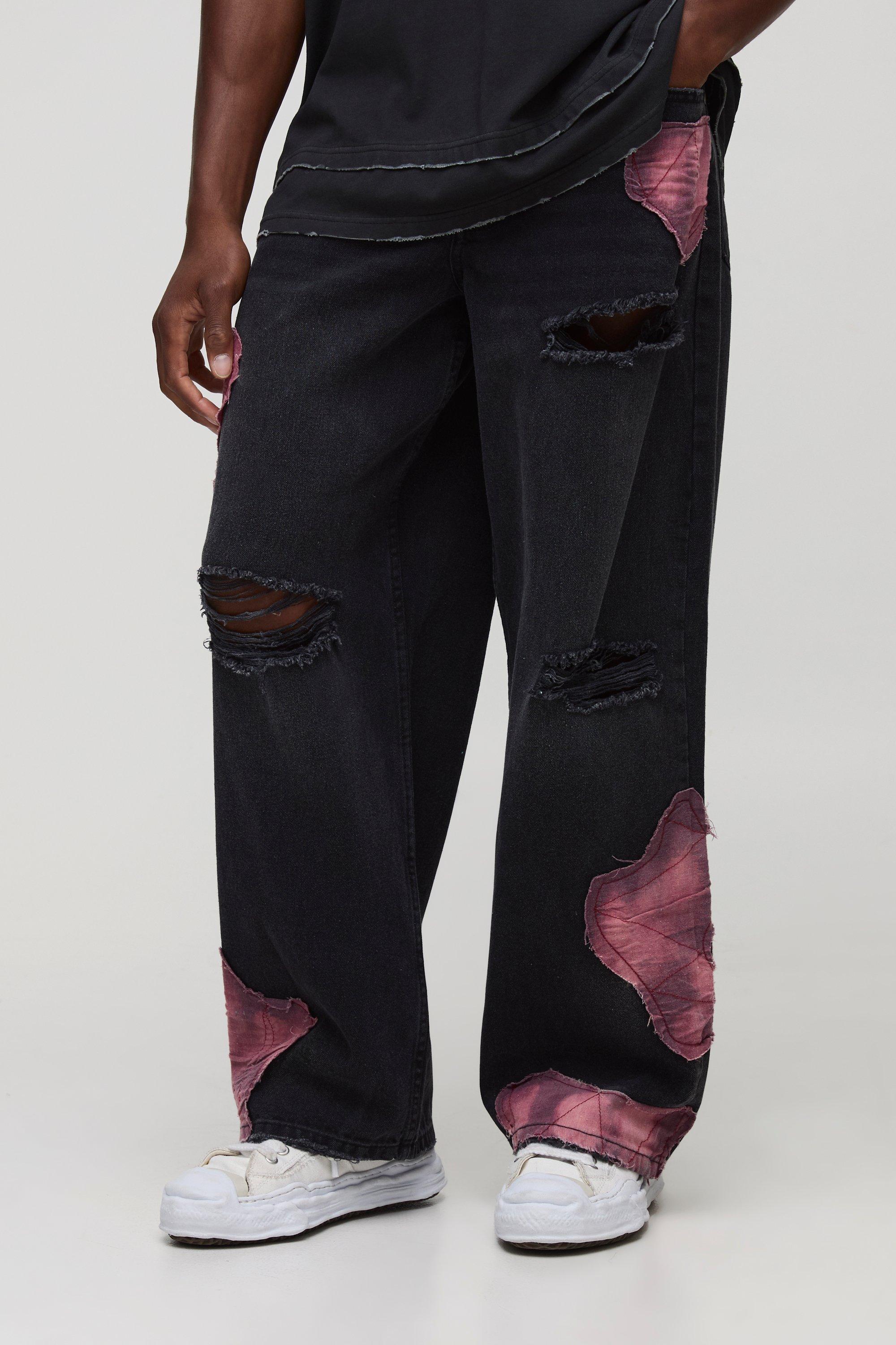 Image of Jeans extra comodi in denim rigido effetto patchwork con strappi & rattoppi, Nero