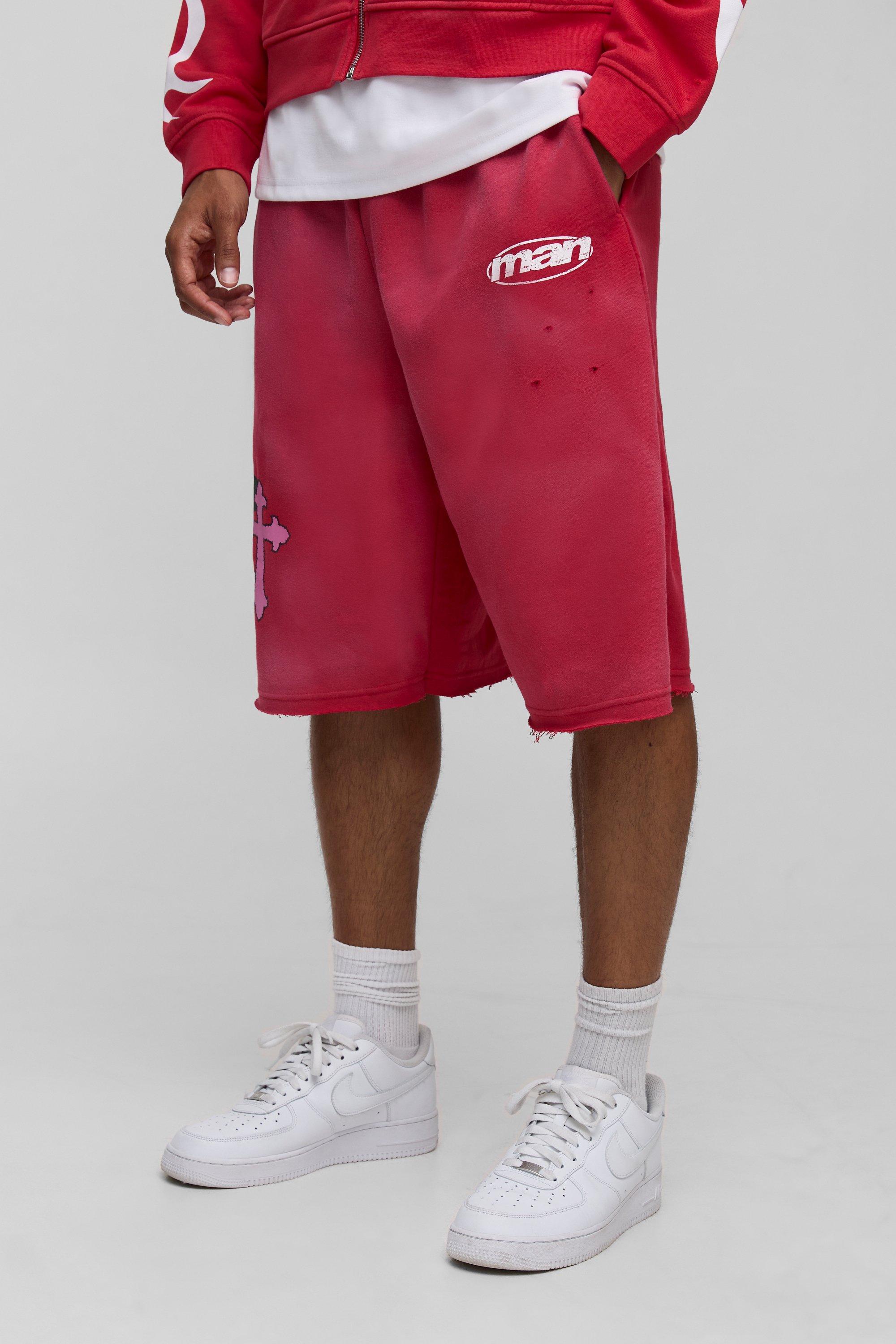 Image of Pantaloni tuta in jersey slavato con grafica incrociata e smagliature, Rosso