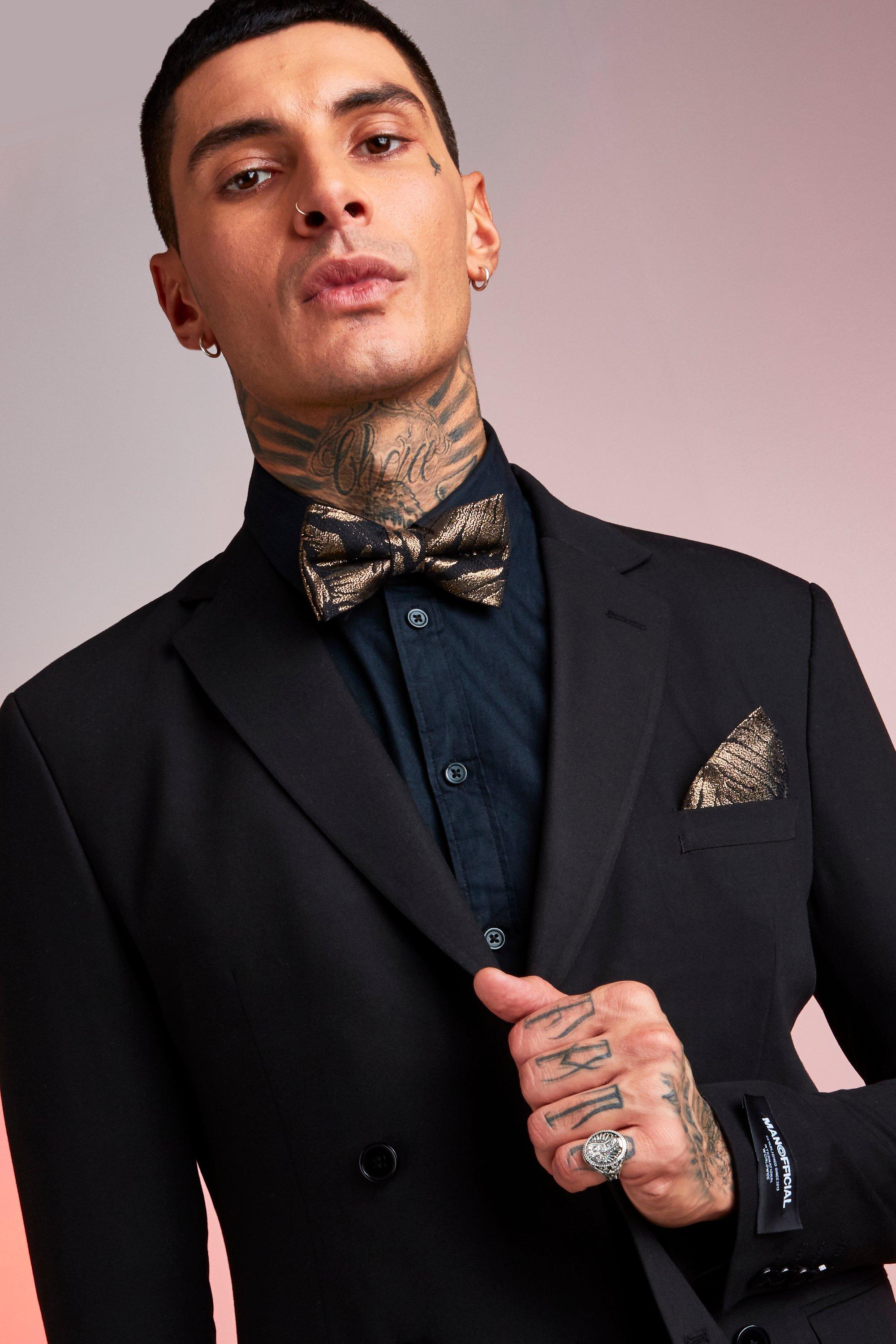 gold bow tie with black suit