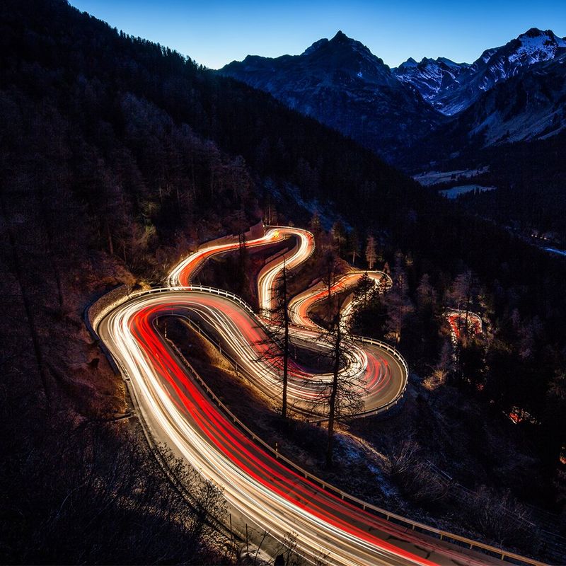 Winding mountain road lit up brightly