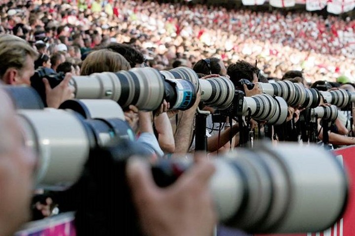 Image of a sports match with many dslrs and some amazing lenses