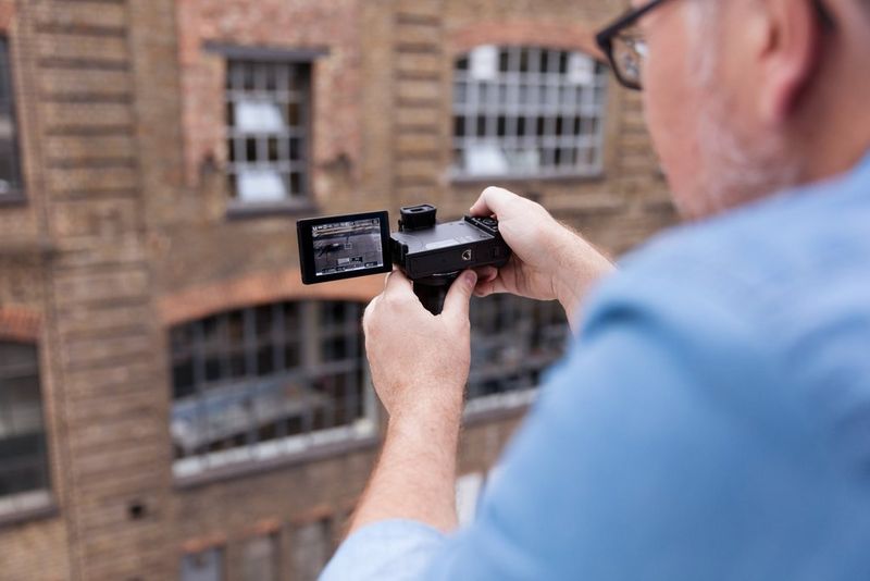 Canon PowerShot G5 X  Mand, der tager foto med flash og skærm åben