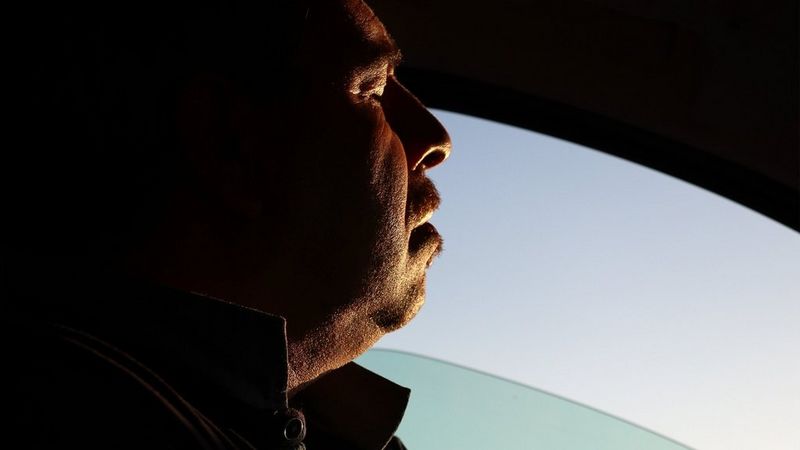 A subject looking out of a car pondering life.