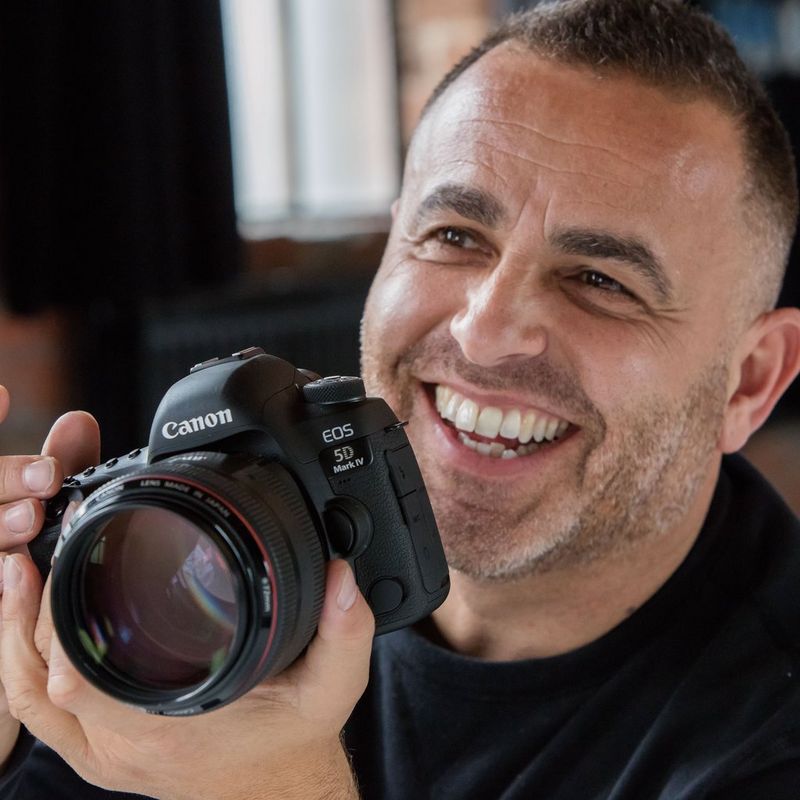 Canon EOS 5D Mark IV Body with Canon Log Man Holding Camera With Front View Of Product