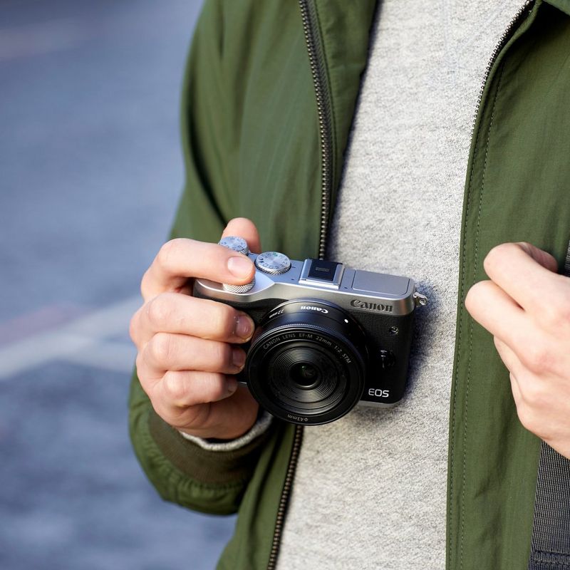 Canon EOS M6 + objectif EF-M 15-45mm IS STM argent 0 Un homme tenant l'appareil photo
