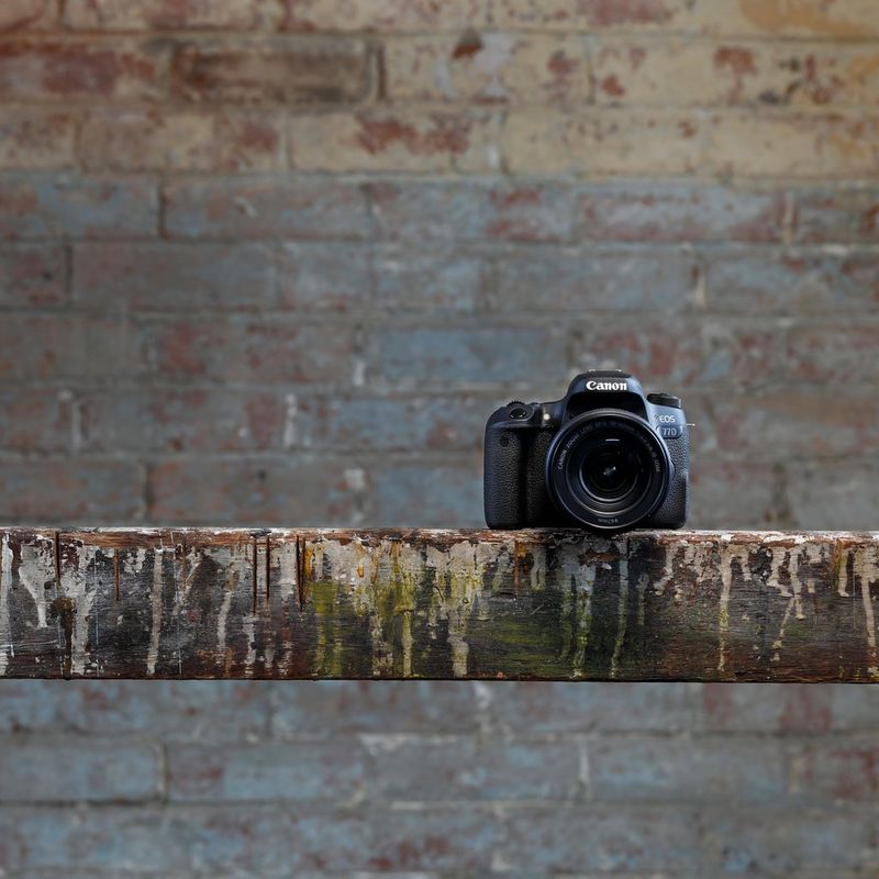 Canon EOS 77D + EF 18-55mm IS STM Lens + Backpack + Spare Battery Camera With Background Of Brick Walls