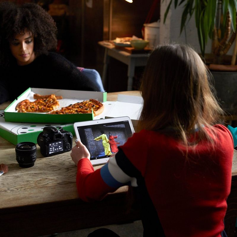 Canon EOS 77D + EF 18-55mm IS STM Lens + Backpack + Spare Battery Camera Kept On The Table