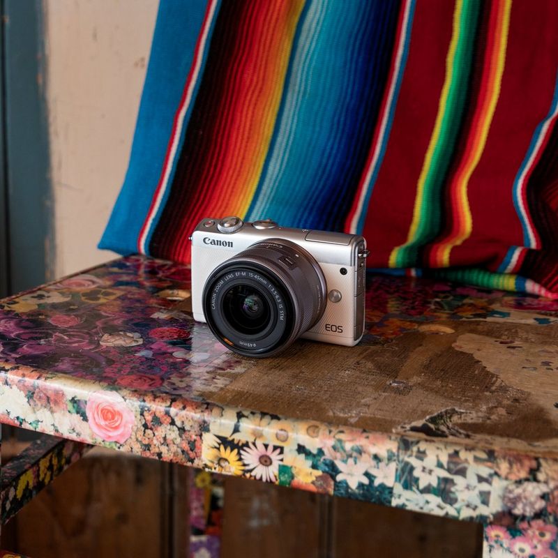 Canon EOS M100 White + EF-M 15-45mm f/3.5-6.3 IS STM Lens Silver The Camera on a Chair