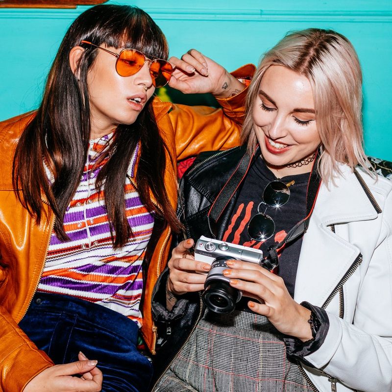 Canon EOS M100 White + EF-M 15-45mm f/3.5-6.3 IS STM Lens Silver Women Reviewing the Image on the Camera