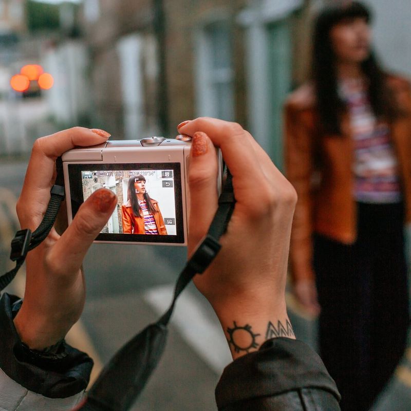 Canon EOS M100 Grey + EF-M 15-45mm f/3.5-6.3 IS STM Lens Silver Taking a Photo on a Street