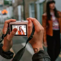 Canon EOS M100 Body - Grey Taking a Photo on a Street