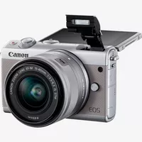 Canon EOS M100 Grey + EF-M 15-45mm f/3.5-6.3 IS STM Lens Silver Product Diagonal View with Built-in Flash and Tilted Screen