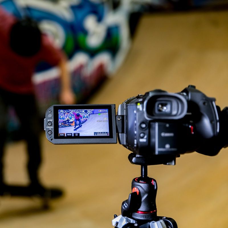 Canon LEGRIA GX10 Back Left View with Flipped Screen on Tripod