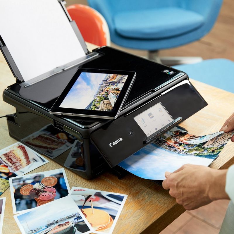 Canon PIXMA TS8150 - Black Product Front View With A Person Operating The Printer