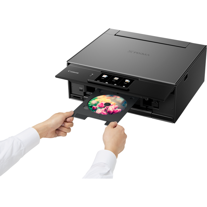 Canon PIXMA TS9140 - Dark Grey Product Front Slant View With A Person Inserting A Compact Disc