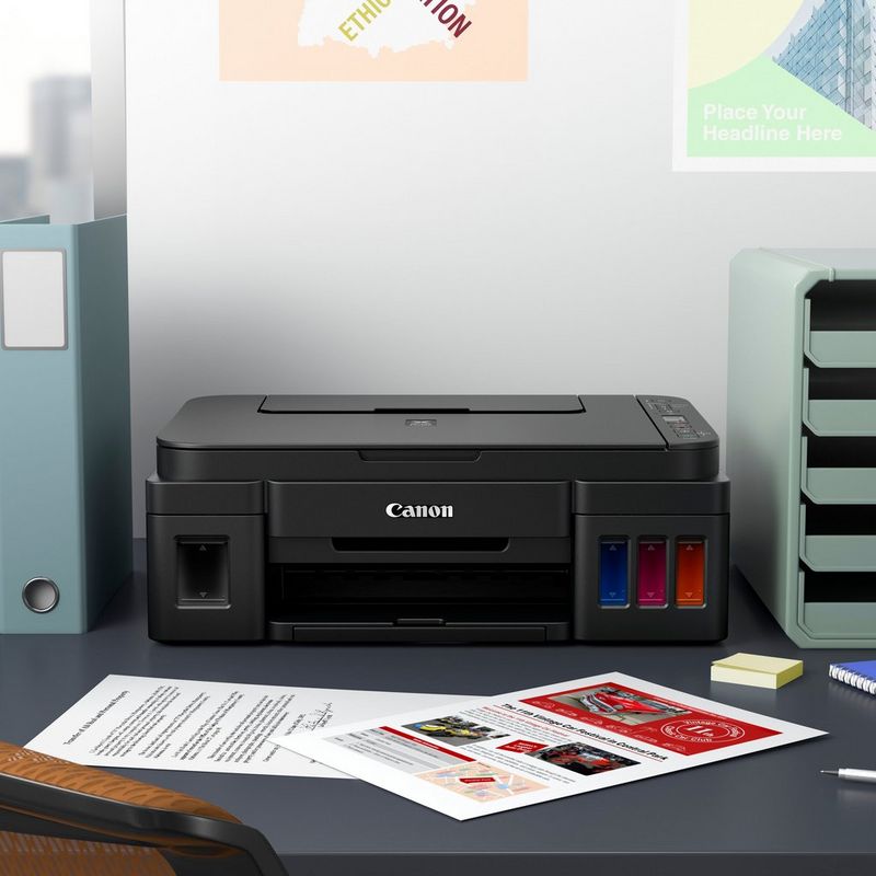 Canon PIXMA G3411 Printer + Extra Black Ink Kept On A Office Table Beside A CPU