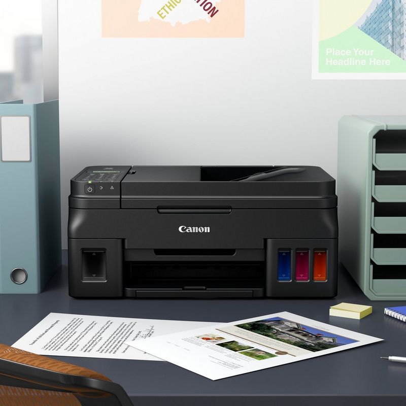 Canon PIXMA G4411 Refillable MegaTank Printer + Extra Black In Kept On A Office Table Beside A CPU