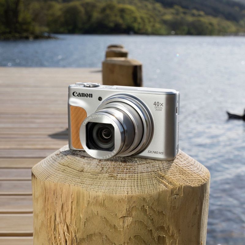 Canon PowerShot SX740 HS - Silver camera on a wooden log