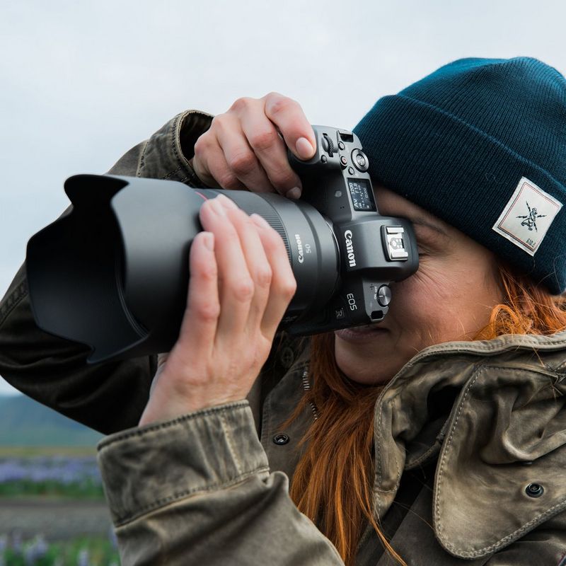 Canon RF 50mm F1.2L USM Lens A Woman Holding a Camera to Her Face