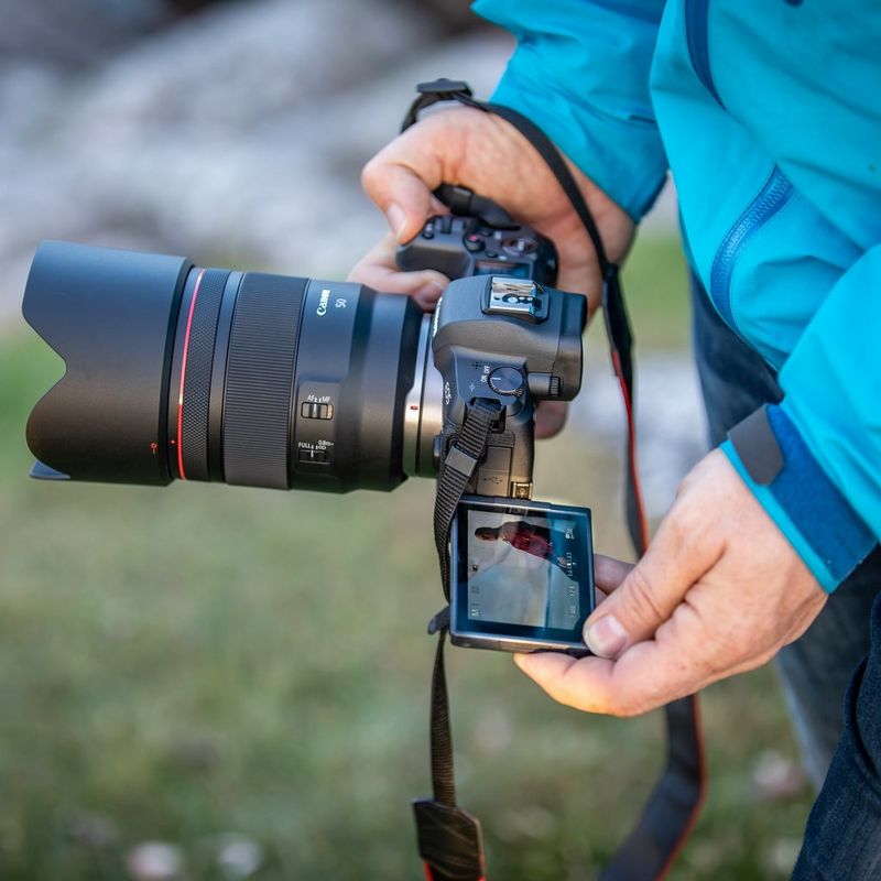 Canon RF 50mm F1.2L USM Lens Men Reviewing the Images on the Camera Screen