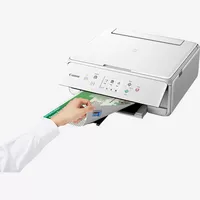 Canon PIXMA TS6251 All-In-One inkjet printer, White Product Front Slant View With A Person Checking the Printout