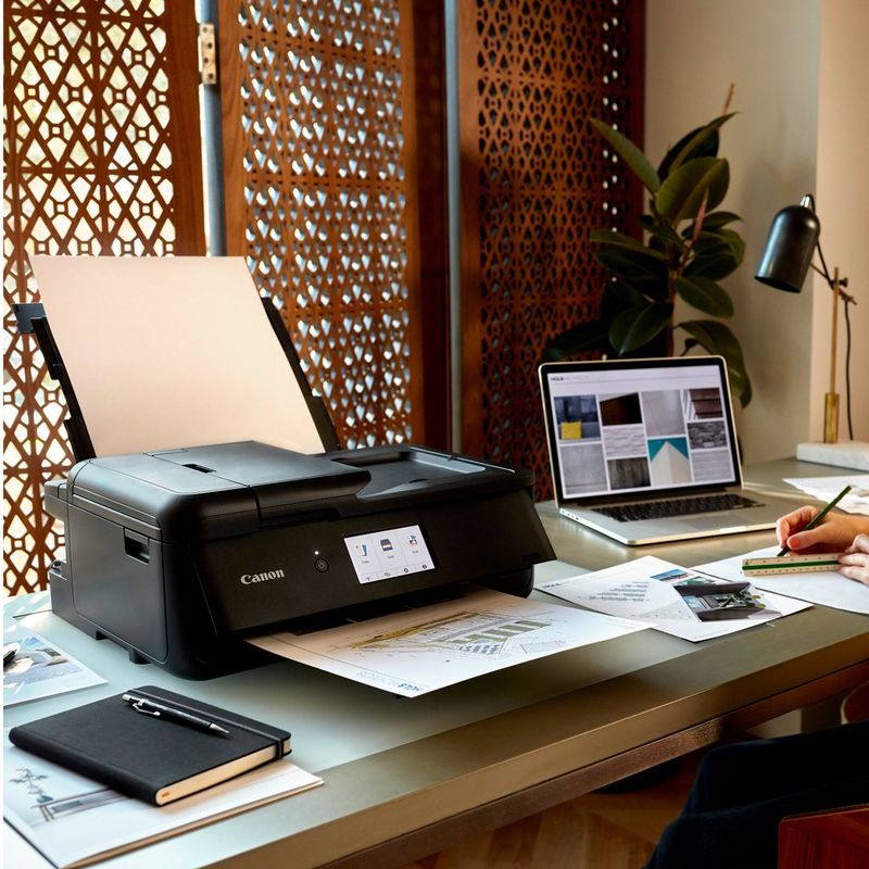 Canon PIXMA TS9550 Wireless A3 Colour All in One Inkjet Photo Printer, Black Kept On A Office Table Beside a Laptop