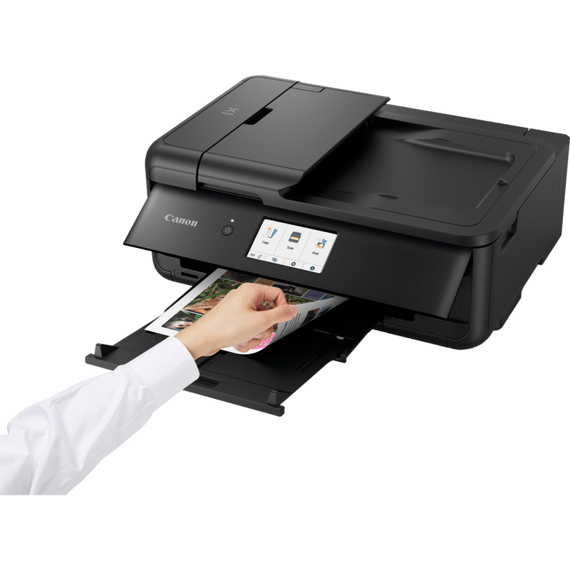 Canon PIXMA TS9550 Wireless A3 Colour All in One Inkjet Photo Printer, Black Product Front Slant View With A Person Checking the Printout