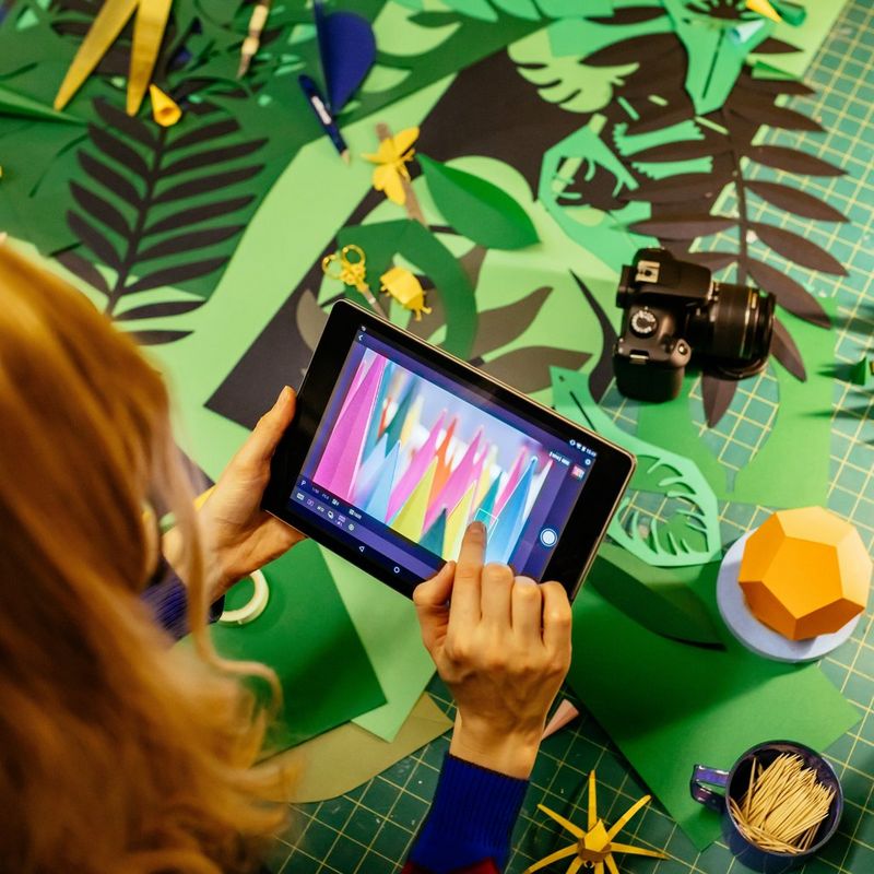 Canon EOS 4000D Body + EF-S 18-55mm III Lens Woman Looking At A Picture On Her Tablet