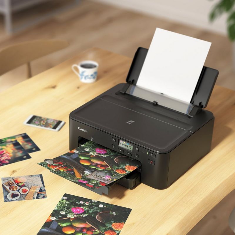 Canon PIXMA TS705 Inkjet Printer Kept On A Table Along With Other Photos