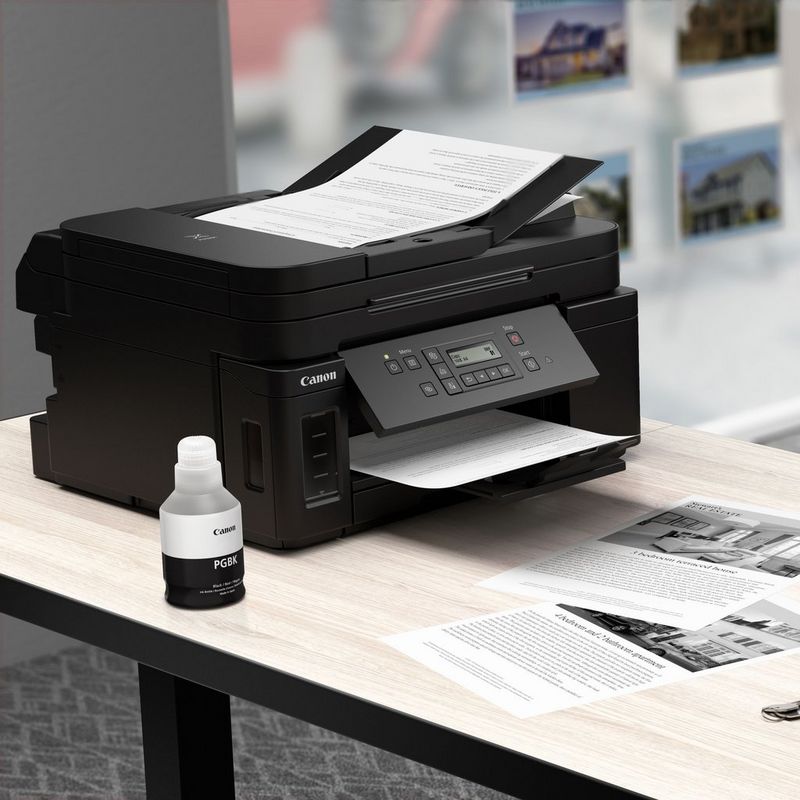 Canon PIXMA GM4050 Refillable MegaTank Inkjet Printer Kept On A Table Along with the Black Ink Bottle
