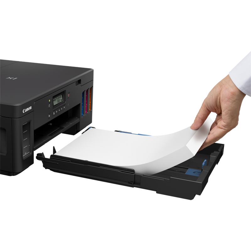 Canon PIXMA G5040 Refillable MegaTank Printer Product Slant View With A Person Adding Paper To The Paper Feeder Tray