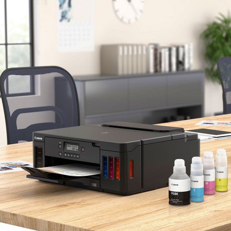 Canon PIXMA G5040 Refillable MegaTank Printer Kept On A Table With Paper Tray Out Along With Ink Bottles