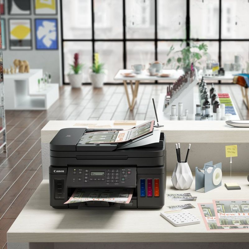 Canon PIXMA G7040 Refillable MegaTank Inkjet Printer Product Front View With A Person Printing From a Smartphone