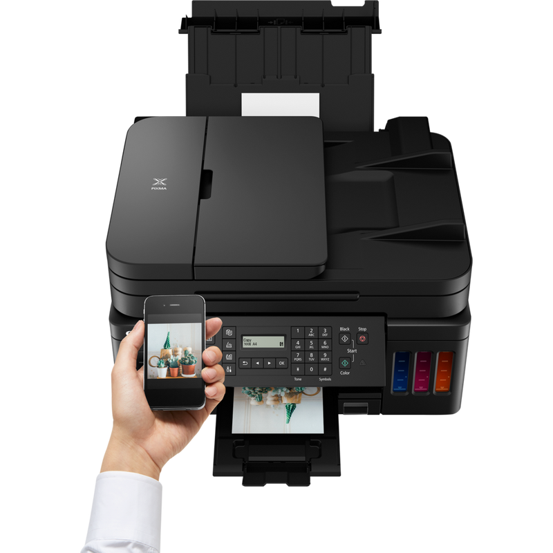 Canon PIXMA G7040 Refillable MegaTank Inkjet Printer Product Front View with A Person Refilling the Yellow Ink Tank