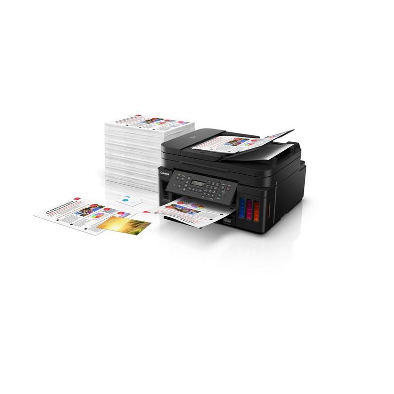 Canon PIXMA G7040 Refillable MegaTank Inkjet Printer Product Slant View With A Person Adding Paper To The Paper Feeder Tray