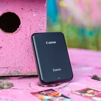 Canon Zoemini Portable Colour Photo Printer, Black Printer in standing position on Pink Desk