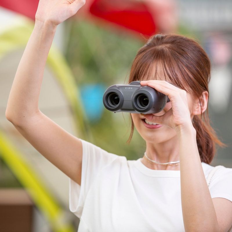 Canon 8x20 IS Binoculars Woman Using Binoculars Outside