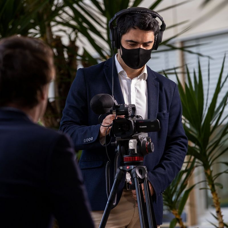 Canon XA45 Camcorder Man Filming with Camcorder on a Tripod