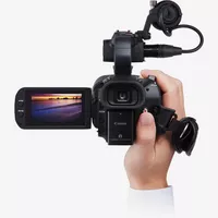 Canon XA40 Camcorder Rückansicht mit ausgeklapptem Bildschirm und Hand, die den Camcorder trägt
