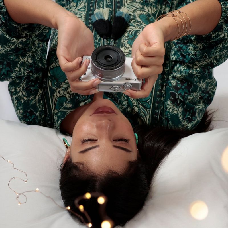 Canon EOS M200 Body - White + EF-M 15-45mm Silver A Woman Lying and Looking at the Camera Screen