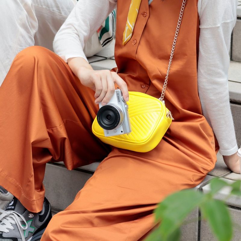 Canon EOS M200 Body - White + EF-M 15-45mm Silver A Woman Holding the Camera