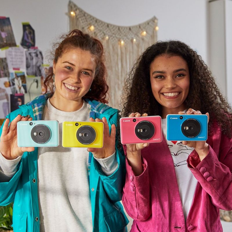 Canon Zoemini C Instant Camera Colour Photo Printer, Bubblegum Pink 2 girls with 4 Printers displayed in hand